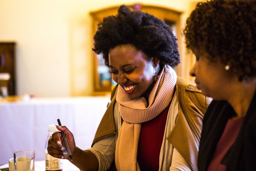 Photo of two women, one is laughing.